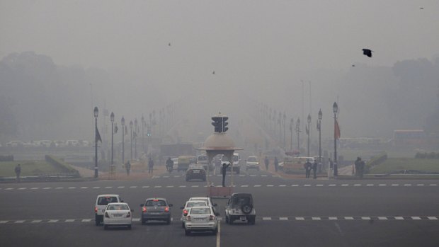 Smog and fog envelop morning traffic in New Delhi. India has forecast of higher carbon emissions as it boosts electricity output over the coming decades.