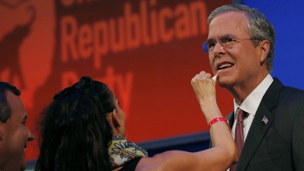 Jeb Bush gets a touchup from a makeup artist before the debate. 