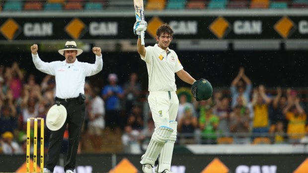 Umpire Illingworth signals six as Joe Burns celebrates reaching his maiden Test century.