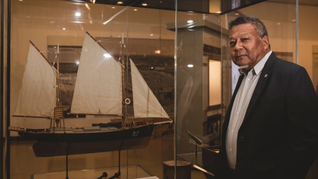 Peter Yu with a model of a wooden pearl lugger.