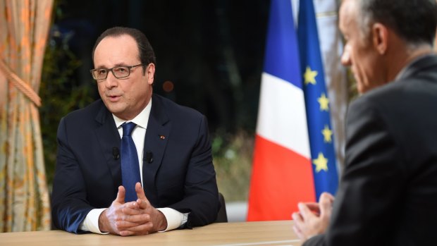 French President Francois Hollande, left, prepares to speak with journalist Gilles Bouleau, right, on French TV on Thursday.