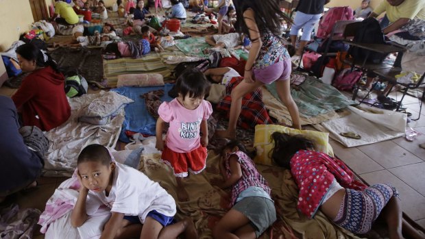 Residents living along coastal areas in Manila take shelter in an evacuation centre.
