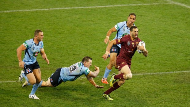 Standout: Greg Inglis outstrips the Blues defence to score for Queensland.