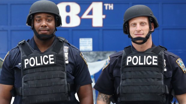 Jamal Skinner, left, and Evan Aronowitz model ballistic body armour ahead of NYPD plans to distribute 20,000 helmets and 6,000 vests to patrol officers before the end of the year. 