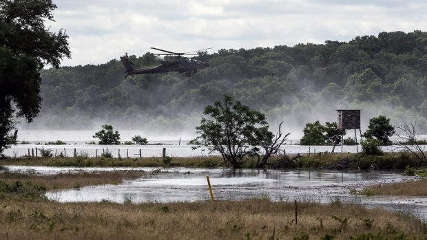 Army helicopters hover above Lake Belton.