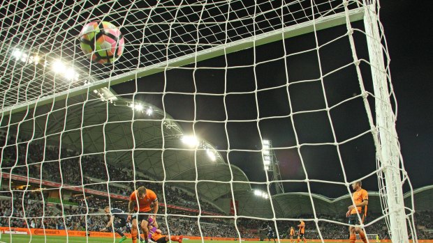 Back of the net: Brisbane defenders watch on as Berisha's heads home.