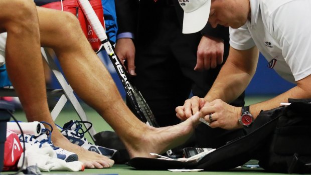 Ouch: Blisters left Djokovic in a world of pain during the final.