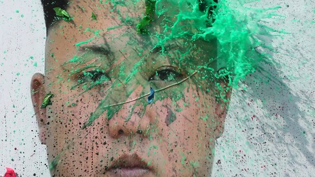 A liquid-filled balloon thrown by a North Korean defector bursts on a portrait of North Korean leader Kim Jong-un during a rally in Seoul, South Korea last month.