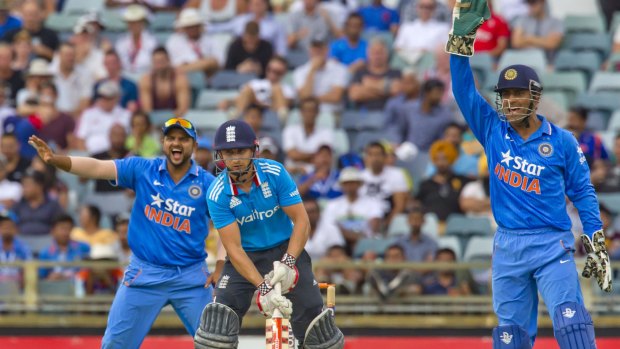 India's captain M.S. Dhoni (right) and Suresh Raina appeal vociferously for a leg-before decison against England's man of the match, James Taylor.