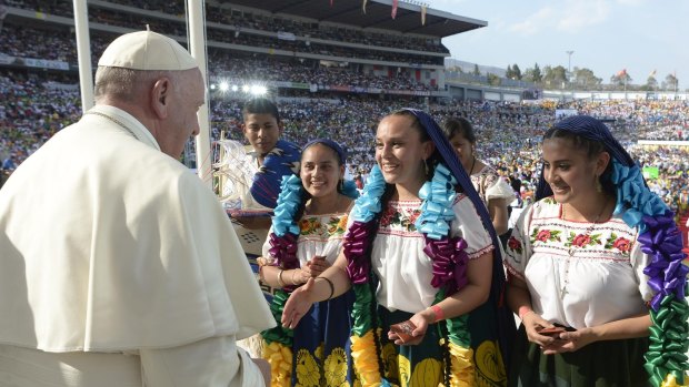 Mexicans wearing traditional costumes greet Pope Francis during a meeting with Mexican youth at Jose Maria Morelos y Pavon Stadium, in Morelia, Mexico. 