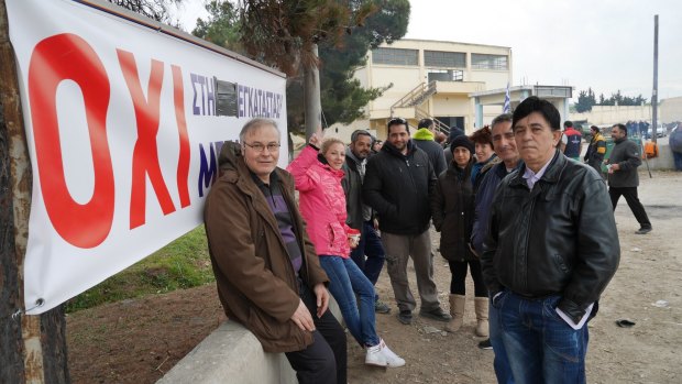 Protesters next to a sign with the Greek word for "No" outside a refugee camp near Thessaloniki.