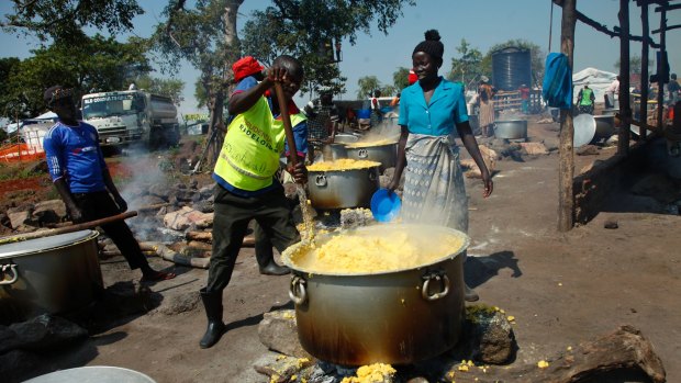 Refugees make maize porridge at a transit centre for South Sudanese refugees in the remote north-western district of Adjumani, Uganda.