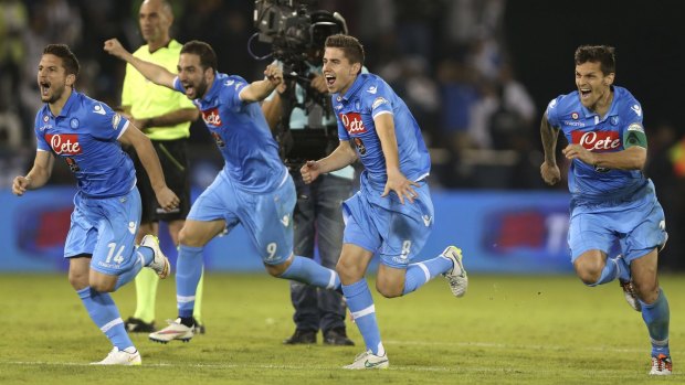 Jubilation: Napoli players run to celebrate after the winning penalty.