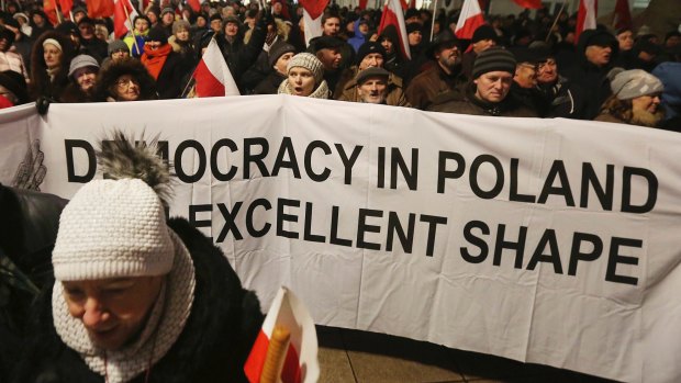 Supporters of the ruling Law and Justice party  at a pro-government rally in front of the presidential palace, in Warsaw, Poland.