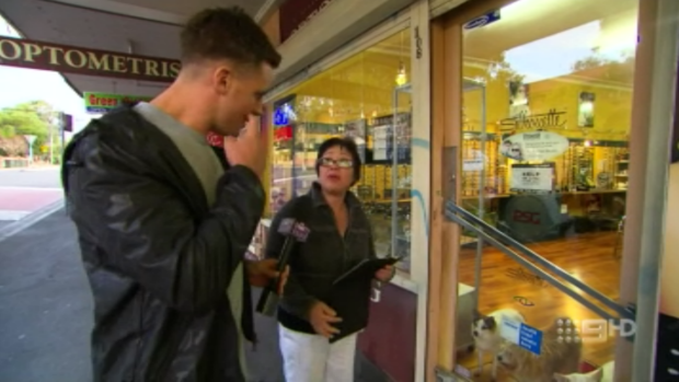 The woman tells Ryan she owns the store and the dogs.