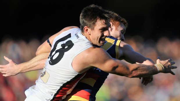 St Kilda's Billy Longer and Adelaide's Tom Lynch contest the ball.