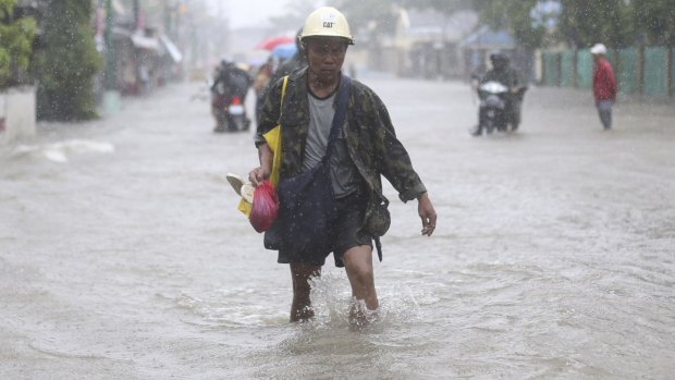 A resident wades in floodwaters bought by Typhoon Hagupit in Camarines Sur province, eastern Philippines, on Monday.