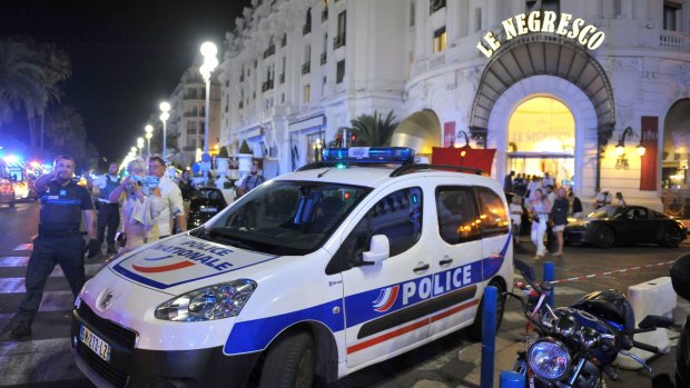 A police car is parked near the scene of the attack.