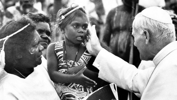 The Pope reaches out to touch young Aboriginal girl on the meeting path at Blatherskite Park in Alice Springs.