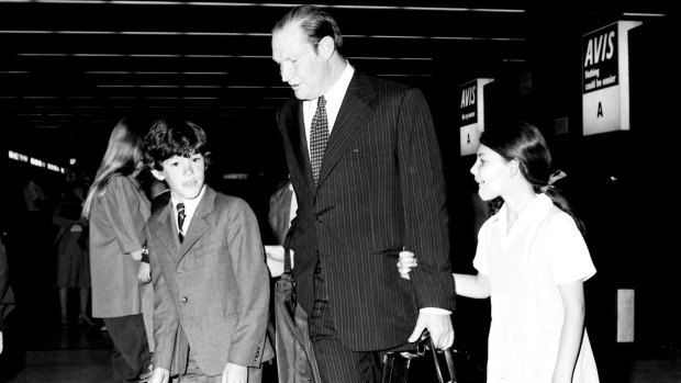 Kerry Packer is greeted at Sydney Airport by his children James and Gretel in 1977.