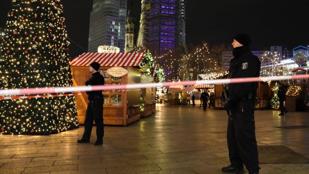 Police guard a Christmas market in Berlin after a truck ploughed into the crowd.