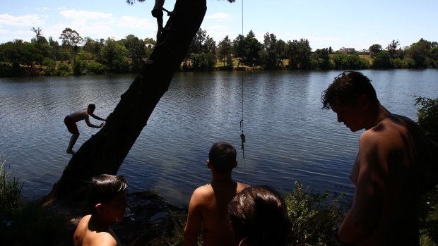 Boys from Penrith cool off in the Nepean River on Saturday.