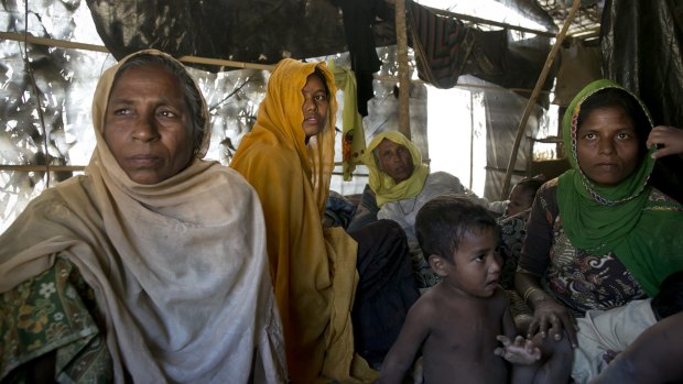Women and children in a makeshift house they share with six others in a Rohingya refugee camp in Cox's Bazar, Bangladesh, after fleeing from Myanmar's Rakhine state.