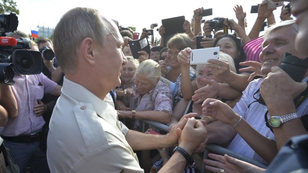 Russian President Vladimir Putin meets people after resurfacing from the Black Sea.