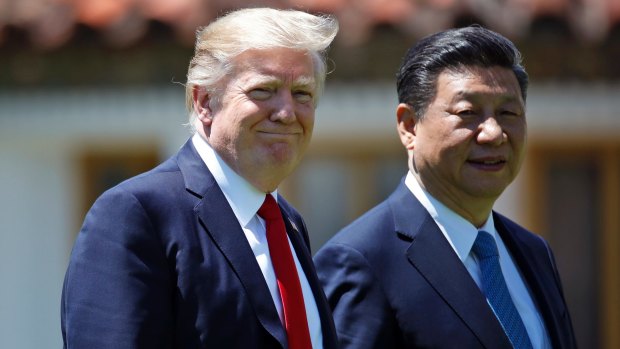 Donald Trump and Chinese President Xi Jinping walk together after their meetings at Mar-a-Lago in Florida.
