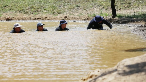 Divers perform a line search in a dam on famr land in Muswellbrook in February, 2015.