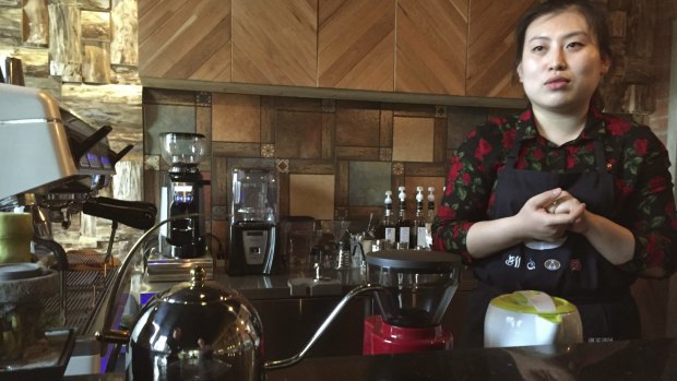 Barista Ri Hyon-a behind the counter of the Kumrung cafe in Pyongyang, North Korea. 