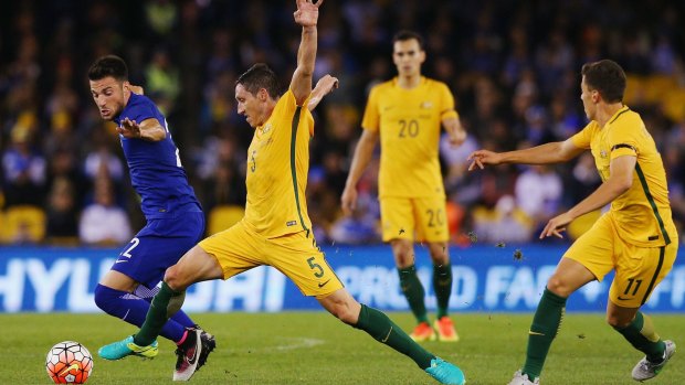 Andreas Samaris of Greece and Mark Milligan of the Socceroos compete for the ball during the friendly at Etihad Stadium on Tuesday night.