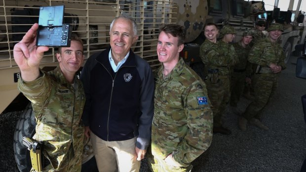 Prime Minister Malcolm Turnbull poses for selfies with ADF trainers and force protection troops at the Afghanistan National Army Officer Academy in Kabul in January.