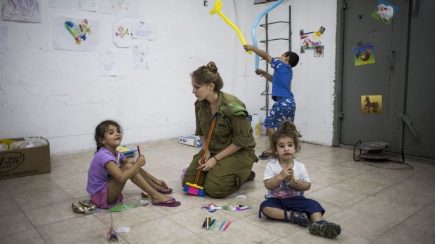 "Indiscriminate attacks": Israeli children sit in a bomb shelter in Ashkelon during the 2014 Israel-Gaza conflict.