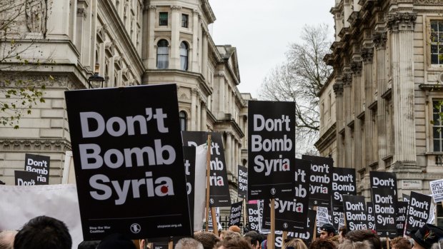 Anti-war signs crowd the skyline outside Downing Street on the weekend oppose British involvement in the bombing of Syria.