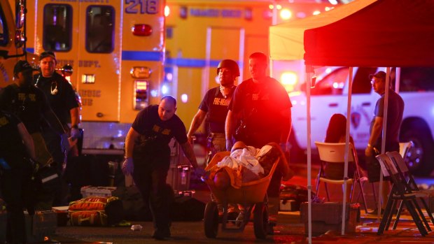 A wounded person is walked in on a wheelbarrow as Las Vegas police respond during an active shooter situation on the Las Vegas Strip.