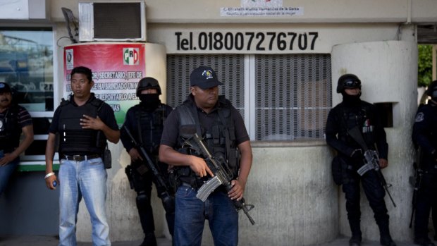 Preventive unit: Federal officers stand guard outside Iguala.