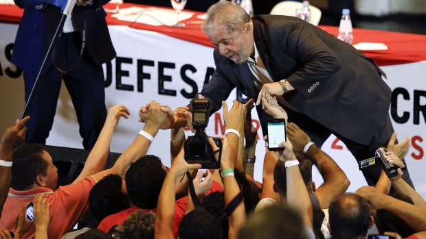 Mr Lula greets supporters in Sao Paulo on Wednesday. He denies any wrongdoing.