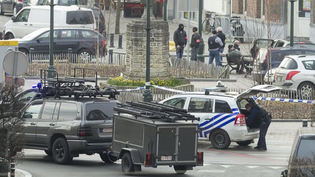 Police cordon off an area in Brussels amid an anti-terror raid linked to last year's Paris attacks.