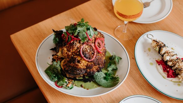 Whole roasted cauliflower with green tahini is one of several Middle Eastern-inspired dishes on the menu.