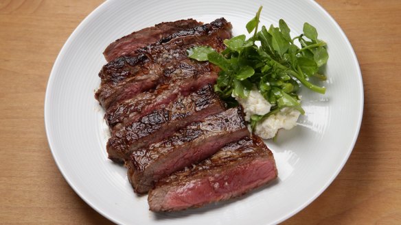 Black angus porterhouse with peppery cress and ricotta.