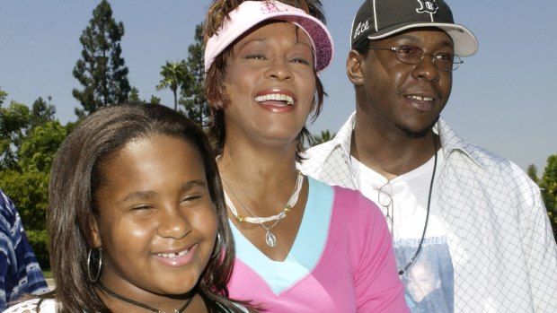 Singer Bobby Brown with his ex-wife, singer and actress Whitney Houston, and their daughter Bobbi Kristina in a file photo taken on August 7, 2004.