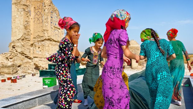 Tomb of an unmarried woman at the 15th-century Seyit Jamal-ad-Din Mosque outside Ashgabat. Young women come here to ask that they will be blessed with babies. The headscarves suggest that these girls are already married.