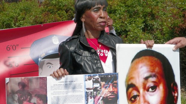 Alice Willis holds a photo of her son, Michael Willis, In New York to show support for Baltimore demonstrators and call for more input by blacks into police operations.