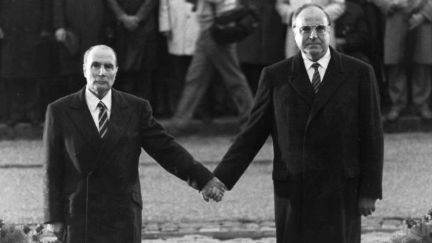 The historic moment when the late French president Francois Mitterrand, left, and German Chancellor Helmut Kohl stood hand in hand in a gesture of reconciliation.