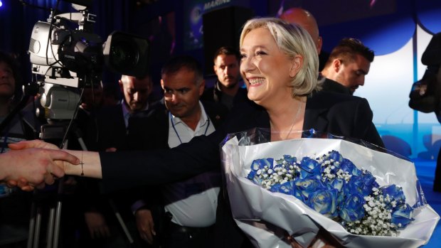 Far-right leader Marine Le Pen with supporters after the release of exit poll results for the first round of the presidential election.