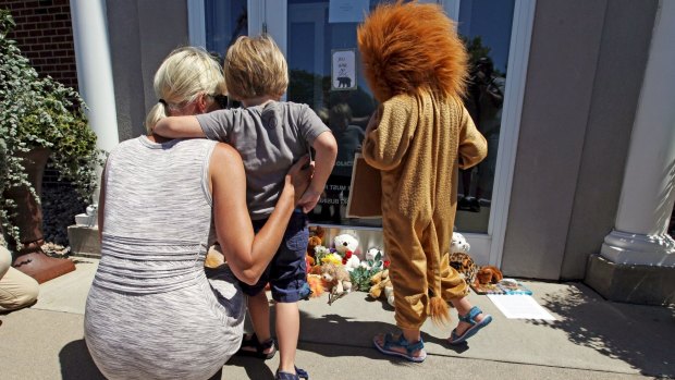 Flowers and stuffed animals have been left outside Walter Palmer's River Bluff Dental practice in Minnesota.