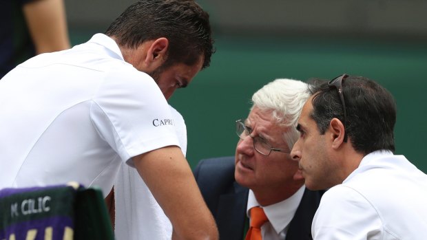 Marin Cilic has treatment on his foot as he takes a medical timeout during the Wimbledon final.