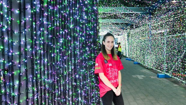 SIDS and Kids head volunteer Gabrielle Weidner, surrounded by Christmas lights in the city.