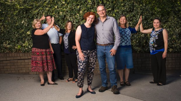Celebrating a last minute reprieve from the ACT government are SHOUT chait Rebecca Davey and patron Jon Stanhope and other staff.